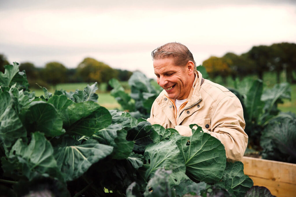 Chef Patron Maurizio Bocchi inspecting locally grown vegetables in the field