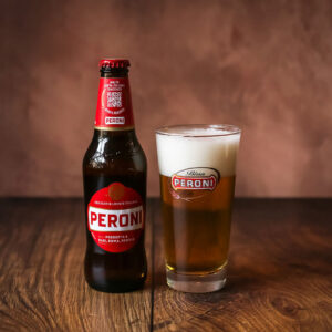 a bottle of Red Label Original Peroni with a glass full of the beer alongside