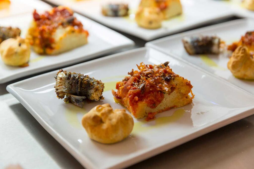 a selection of authentic Italian aperitivo at La Locanda: Cipolline Catanesi, Sarde alla Beccafico, Sfincione Parlermitano