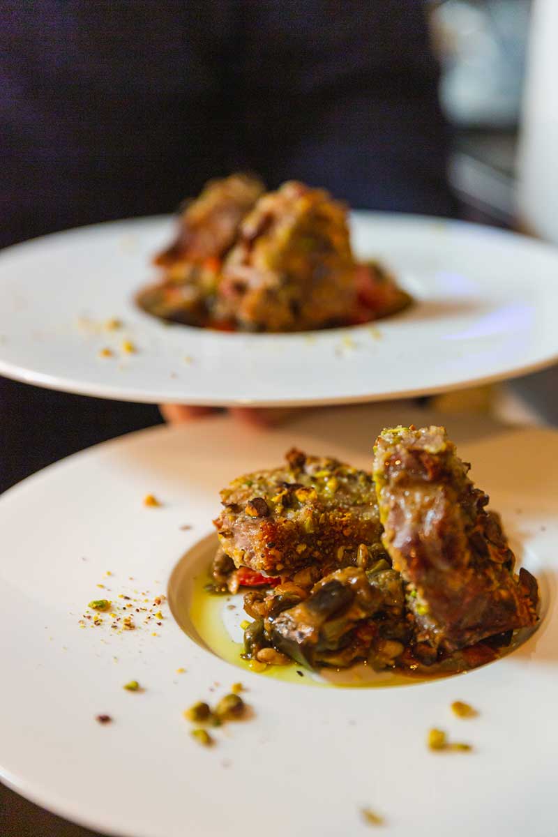 Costolette d’Agnello in Crosta di Pistacchi con Caponata Pistachios - an authetic Italian dish of crusted lamb cutlets served with traditional caponata