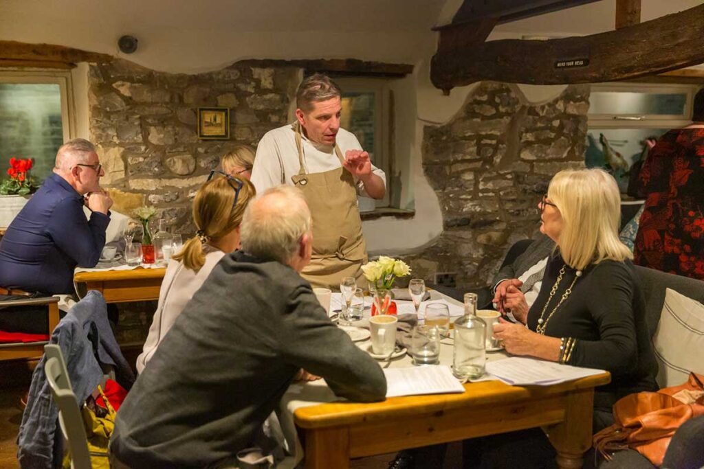 Chef Patron at La Locanda, Maurizio Bocchi, talks to guests about the wine tasting dinner he's just prepared for them