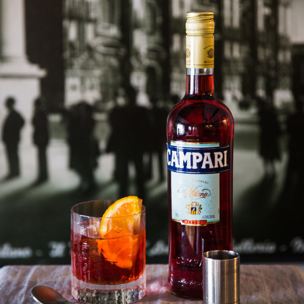 a bottle of Campari and a Negroni cocktail