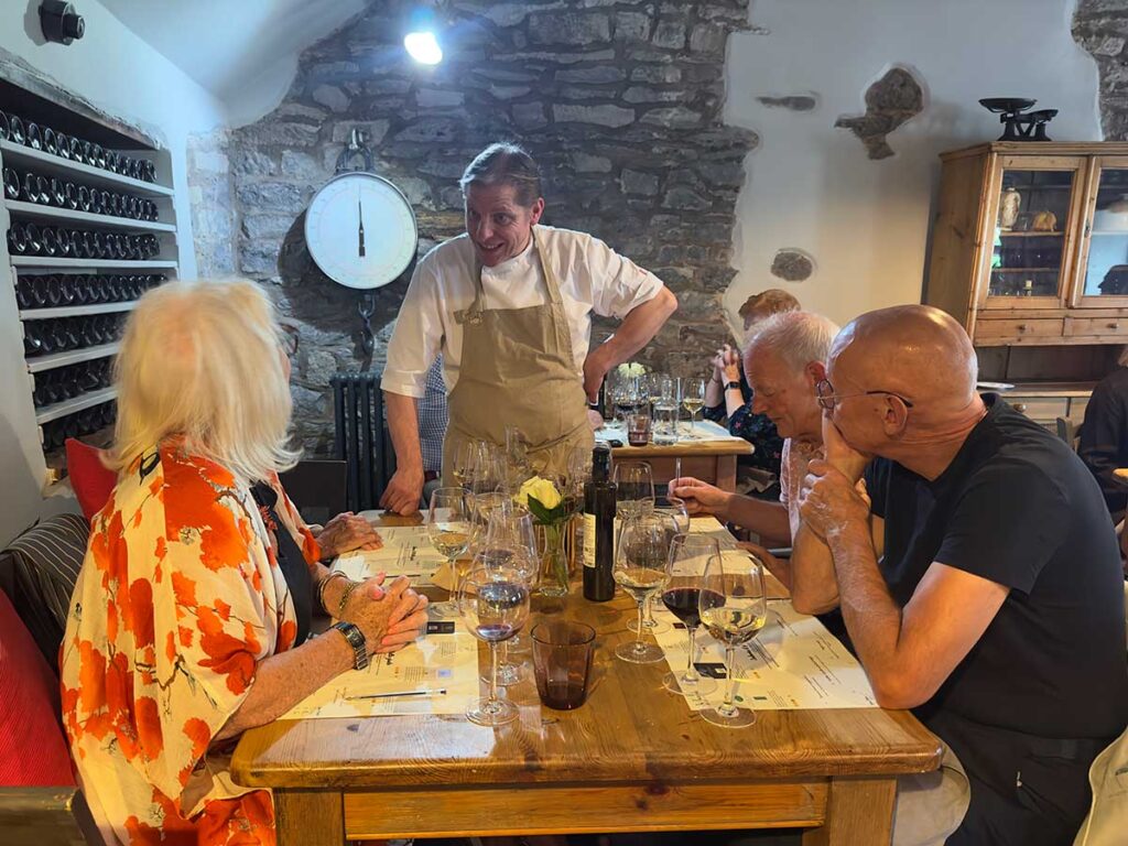 Chef Maurizio Bocchi chatting with diners at La Locanda